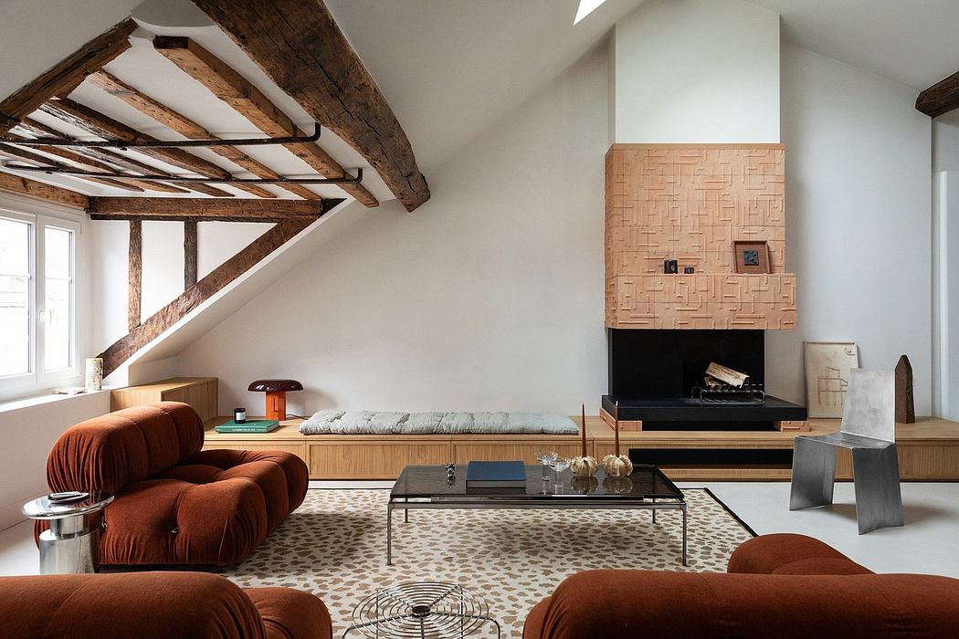 An airy, rustic living space with exposed wooden beams, a textured fireplace, and cozy furniture.