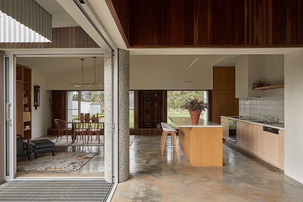 Spacious and rustic interior with wood panels, stone floors, and modern kitchen.