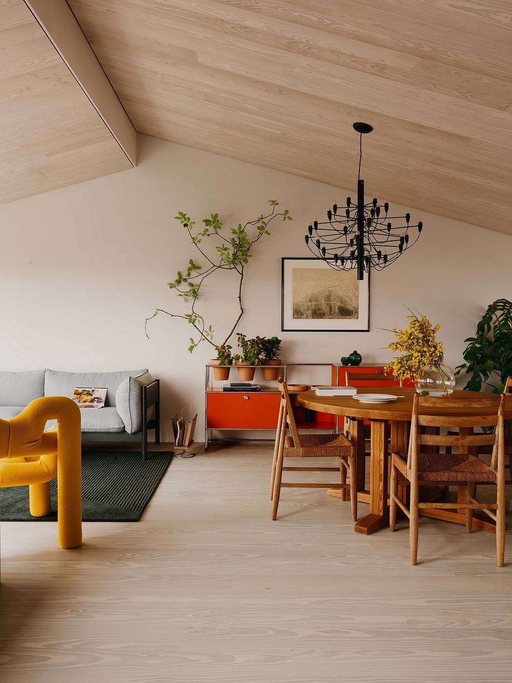 Cozy, earthy-toned living space with wooden beams, mid-century furniture, and vibrant accents.