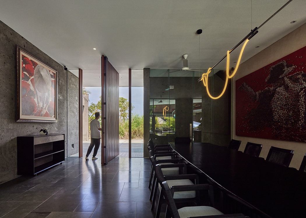 Sleek, modern interior with minimalist furniture, vibrant artwork, and artistic lighting.