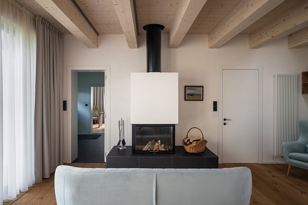 Cozy chalet-style living room with wood-beamed ceilings, fireplace, and minimalist decor.