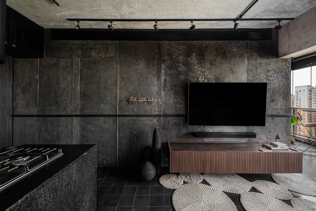 Moody, industrial-inspired living space with concrete walls, track lighting, and wood furniture.