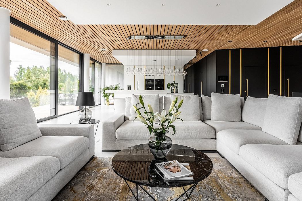 Minimalist yet sophisticated living room with modern wooden ceiling, sleek furniture, and large windows.