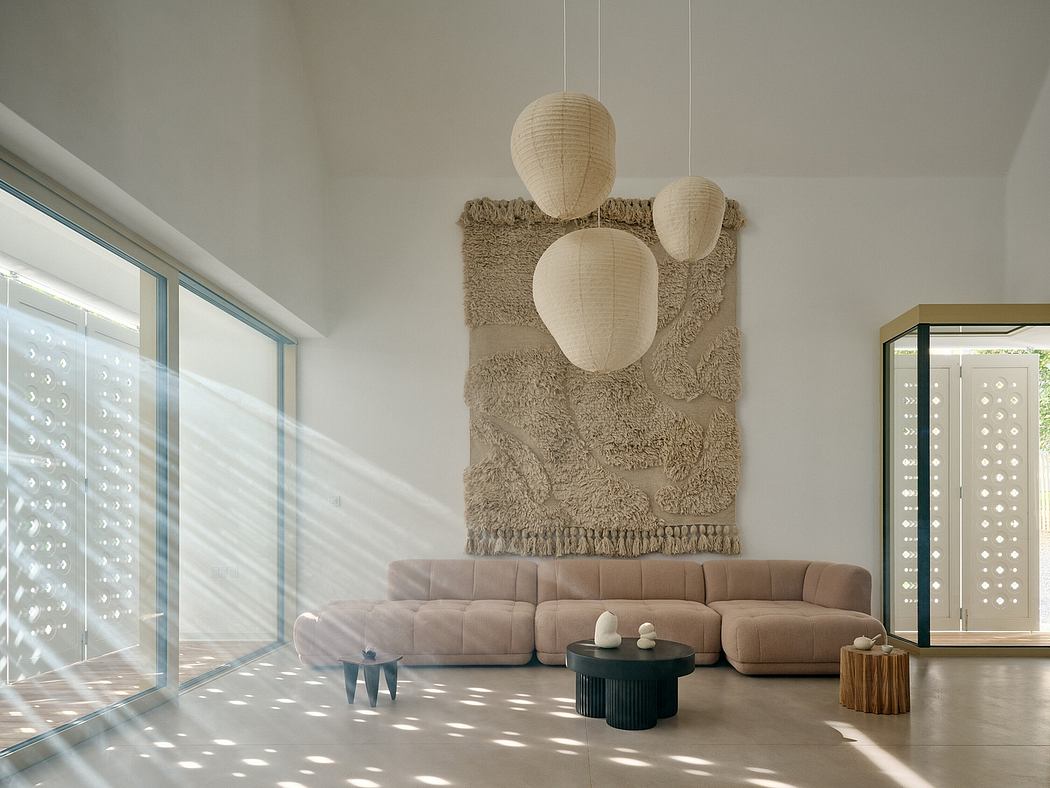 Minimalist living room with textured wall hanging, plush sectional, and modern furnishings.
