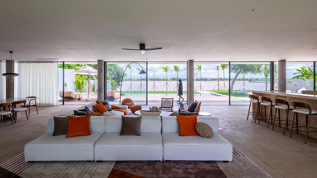 Spacious modern living room with large windows overlooking lush outdoor views.