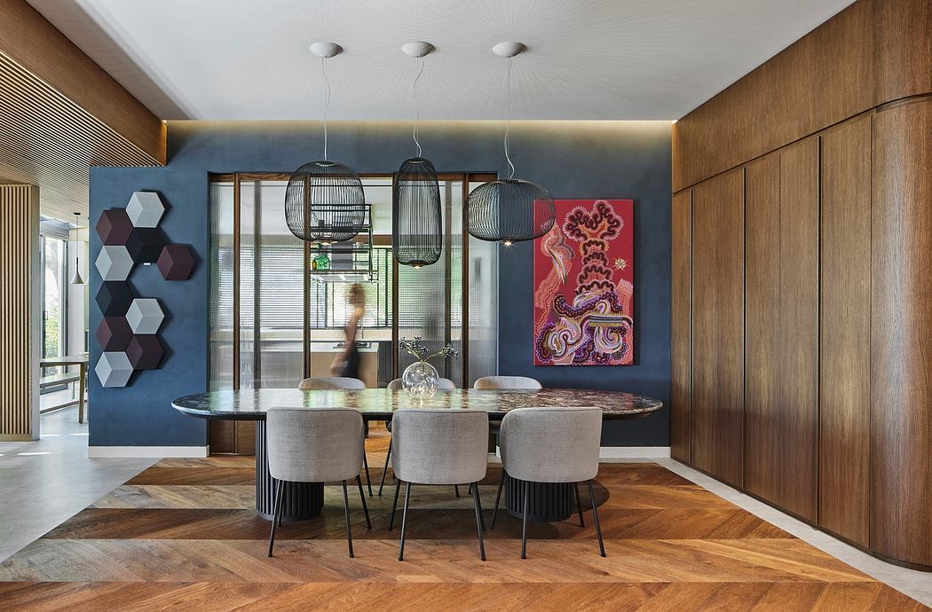 Stylish modern dining room with geometric wall art, pendant lamps, and a wooden table.