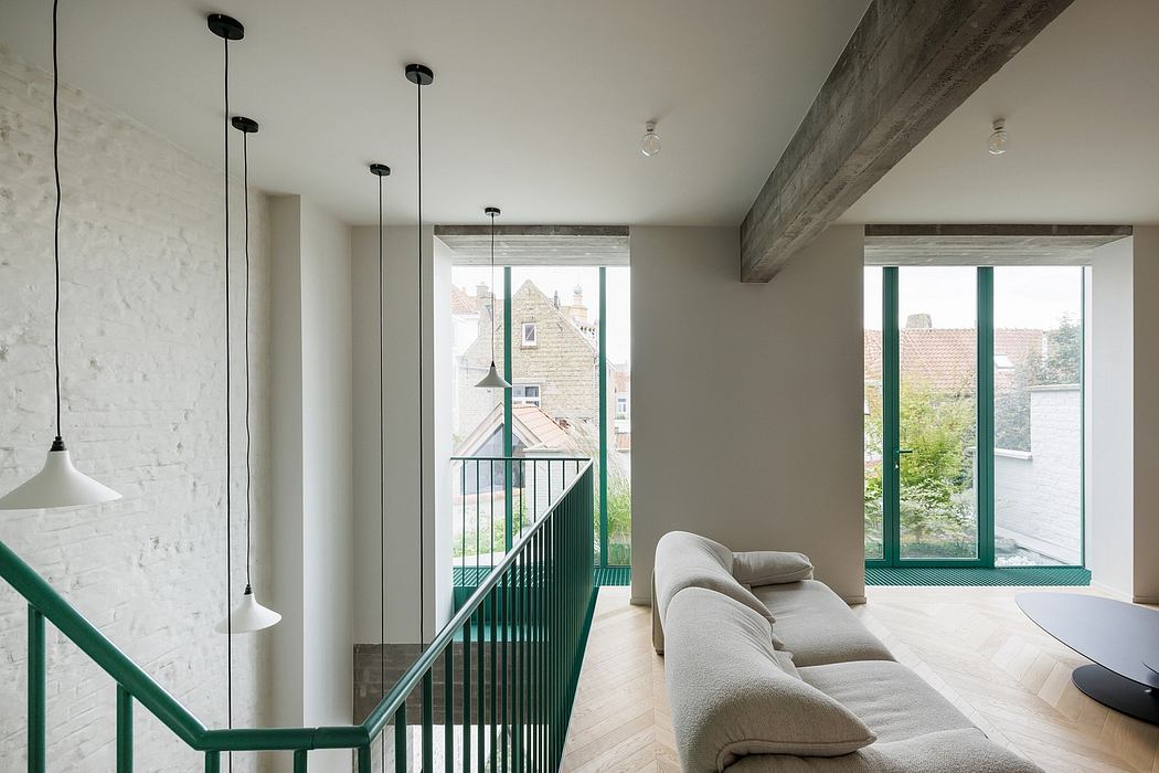 Spacious, modern interior with exposed beams, pendent lights, and large windows overlooking outdoors.