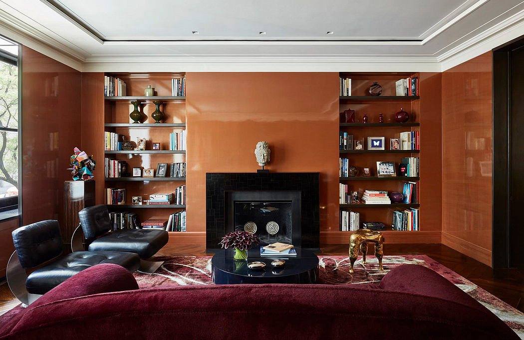 Warm-toned walls, built-in shelves, and a fireplace with decorative objects create a cozy ambiance.