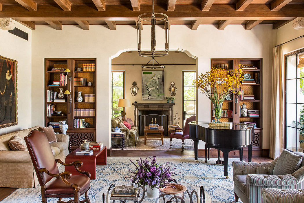 Cozy interior with rustic wooden beams, ornate fireplace, and eclectic furnishings.