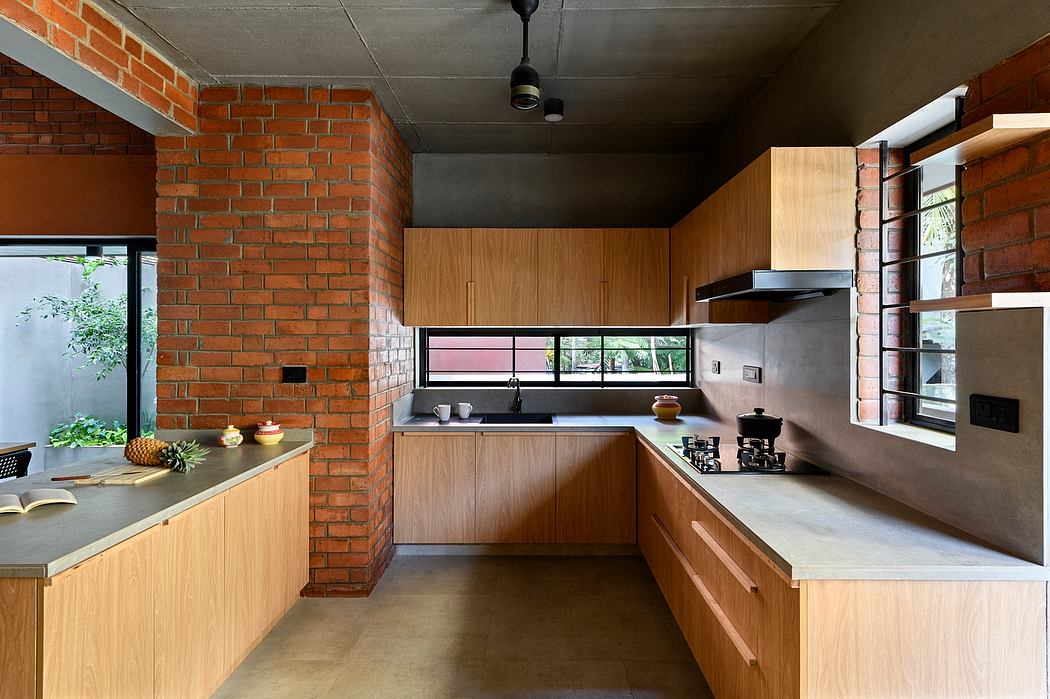 A modern kitchen with brick walls, wooden cabinets, and concrete countertops.