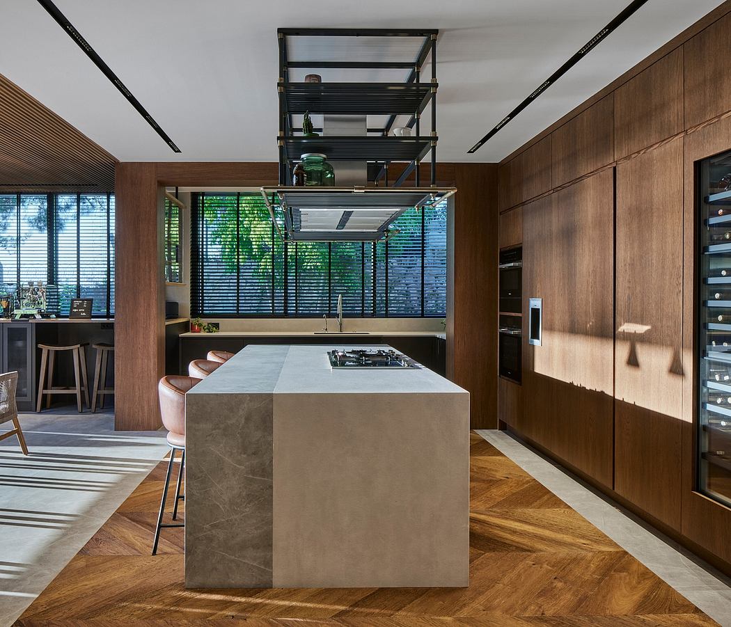 Sleek, modern kitchen with concrete island, industrial shelving, and wood paneled walls.