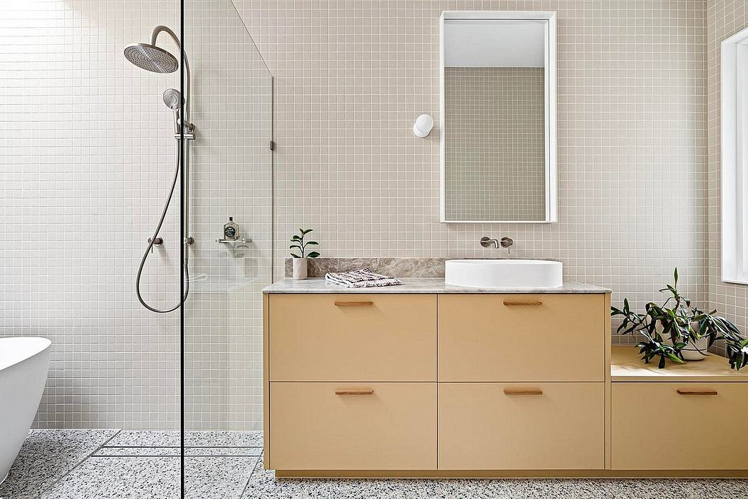 Modern bathroom with white tile walls, wooden vanity, and a shower with a rainfall showerhead.