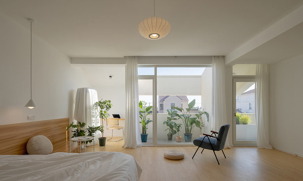 Bright, minimalist bedroom with large windows, potted plants, and modern furnishings.