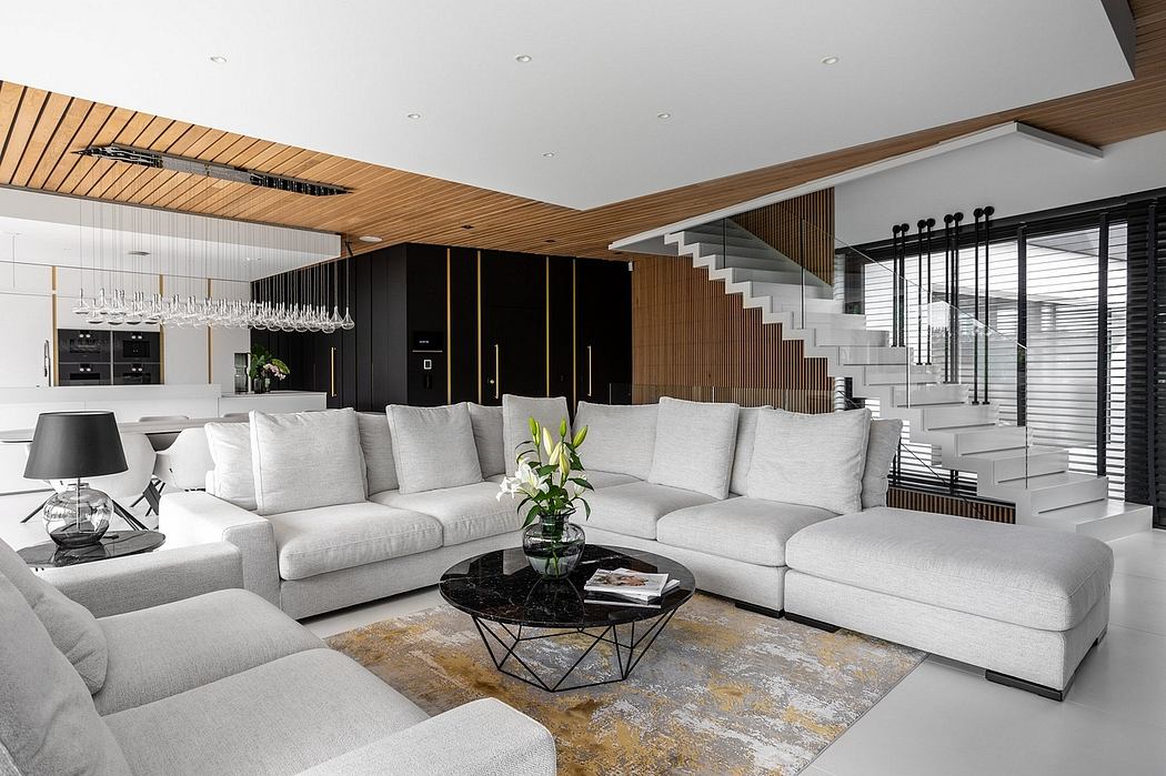 Sleek, modern living room with contrasting wood and black accents, plush seating, and geometric coffee table.