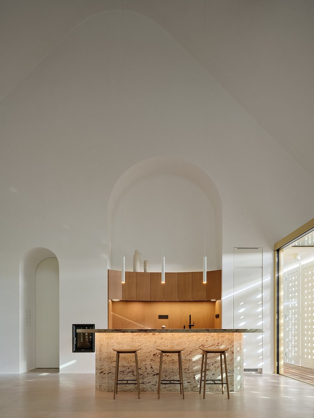 Minimalist kitchen with arched alcove, granite countertop, and wooden cabinets.
