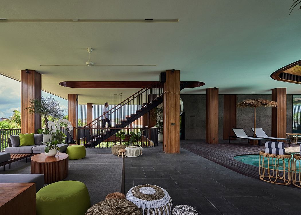 Spacious open-plan lobby with modern wooden architecture, lush greenery, and comfortable seating.