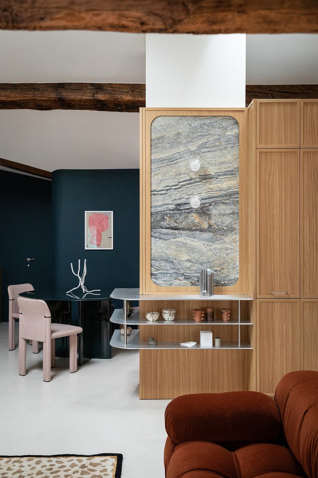 A modern interior with wooden cabinets, marble vanity, and dark accent walls. Minimalist design.