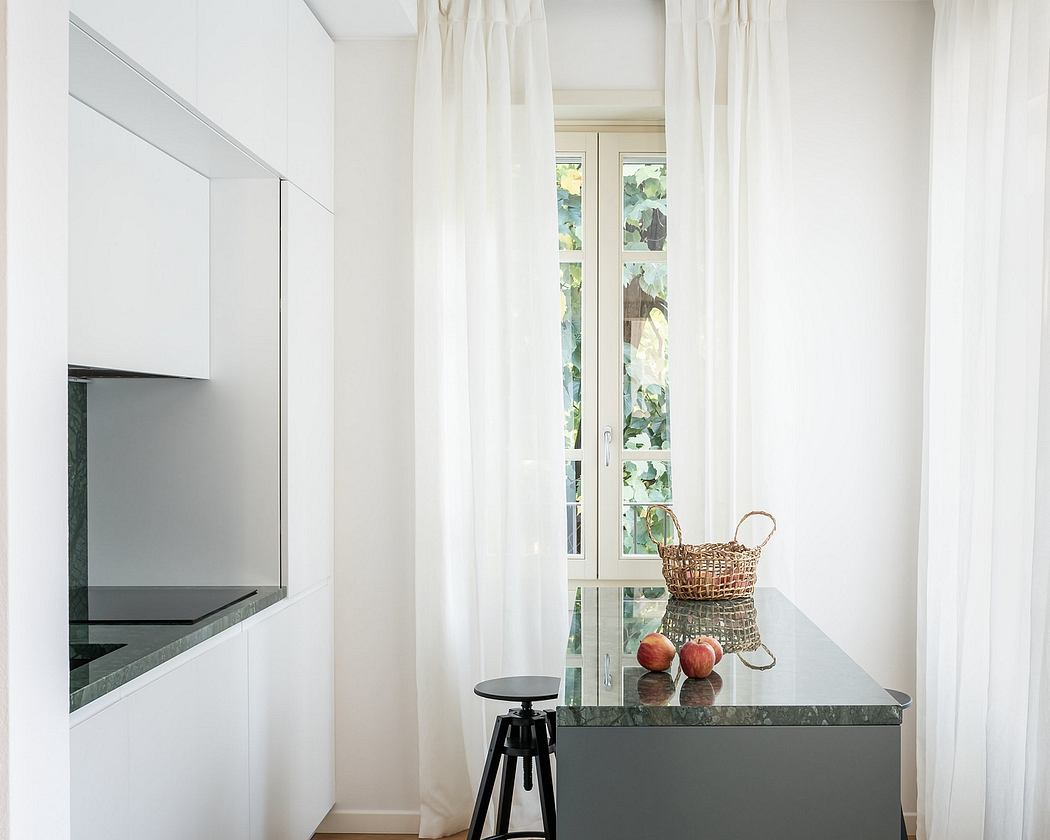 Bright, minimalist kitchen with sleek countertops, curtains, and a wicker basket on the counter.