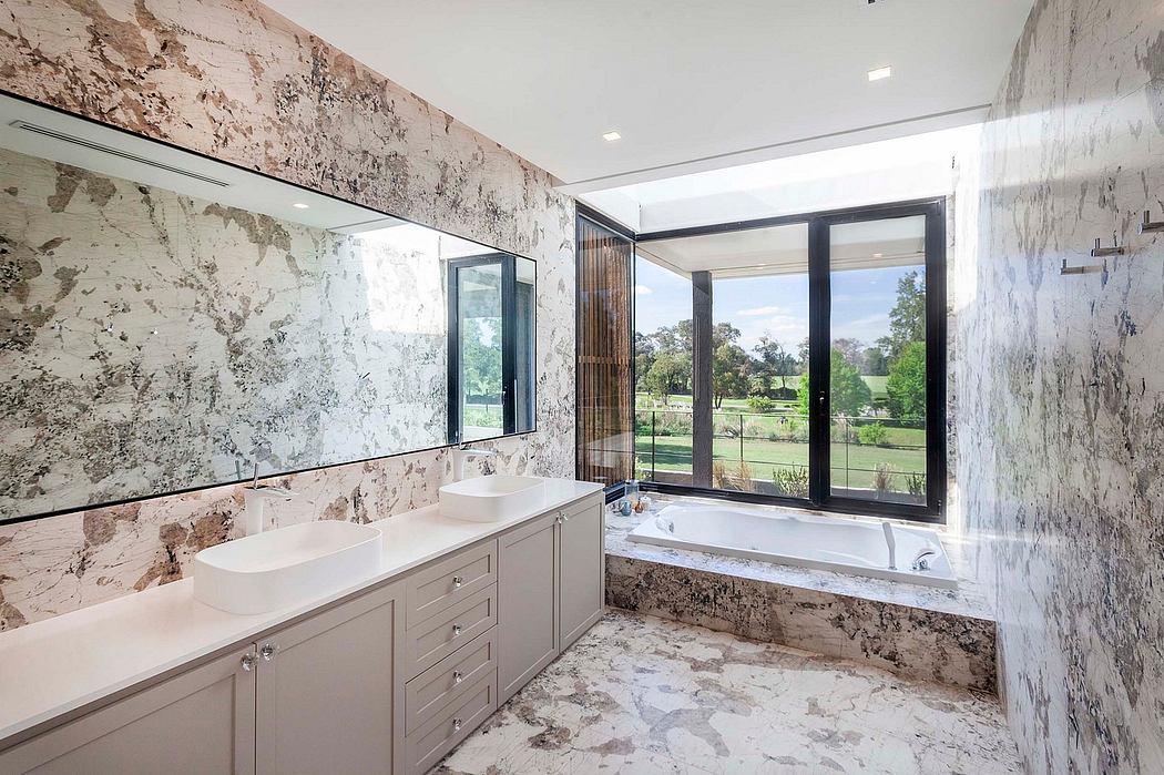 Spacious bathroom with floor-to-ceiling windows, marble walls, and modern vanity.