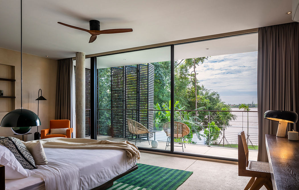 Spacious bedroom with floor-to-ceiling windows, modern ceiling fan, and plush furnishings.