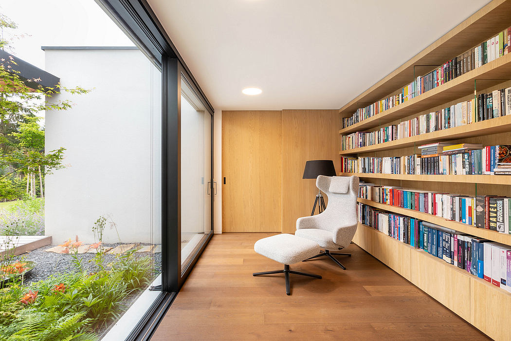 Cozy reading nook with floor-to-ceiling bookshelves, large window overlooking garden.