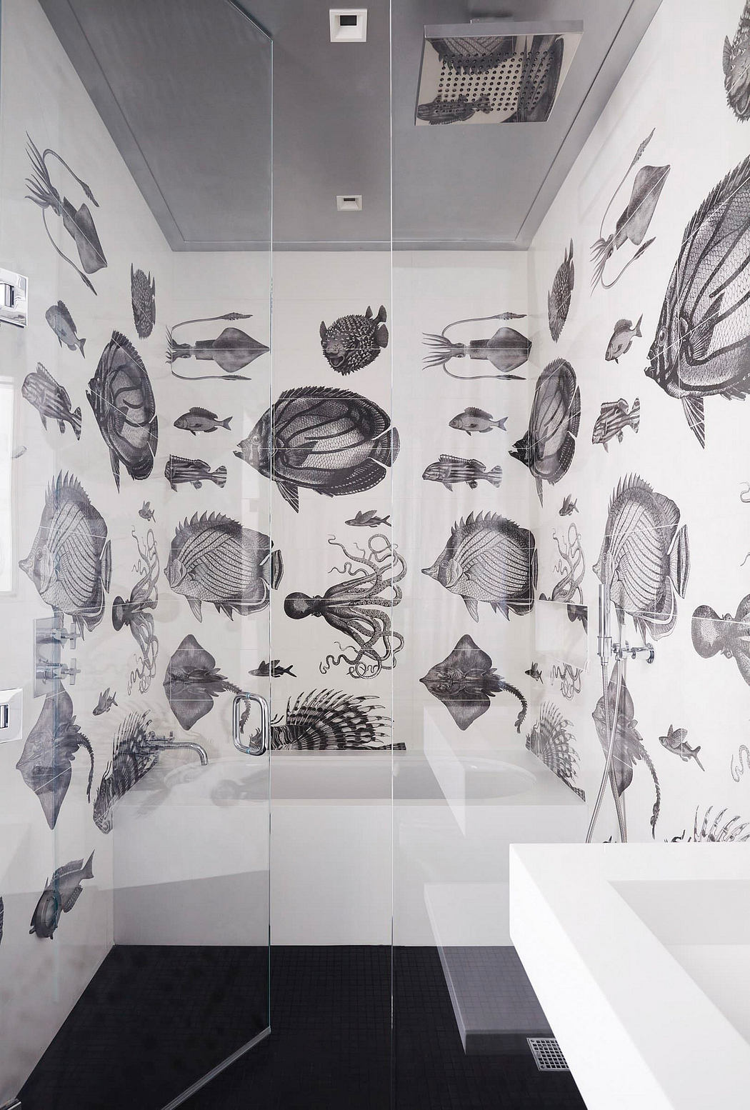 A bathroom with a striking black-and-white fish-themed wallpaper covering the walls.