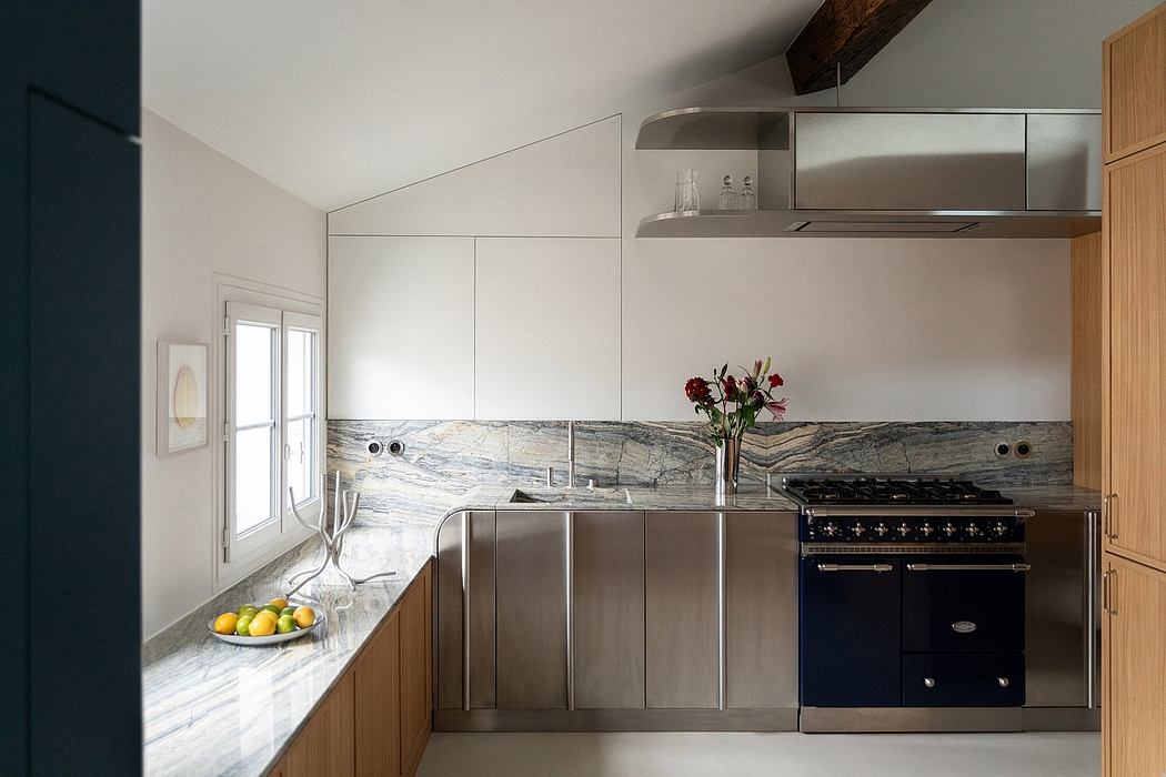 A modern kitchen with sleek stainless steel appliances, marble countertops, and wood cabinetry.