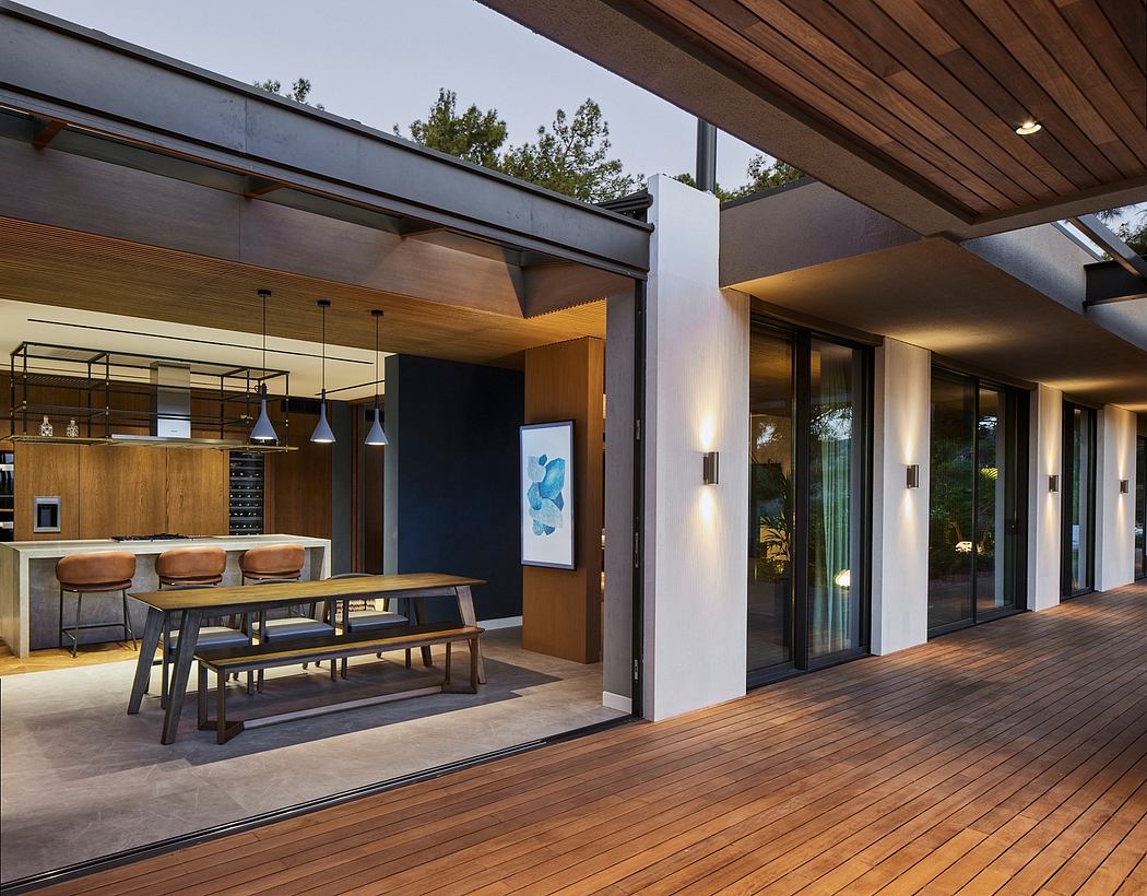 Contemporary home's open-concept kitchen, dining, and living area with wood-paneled ceiling.