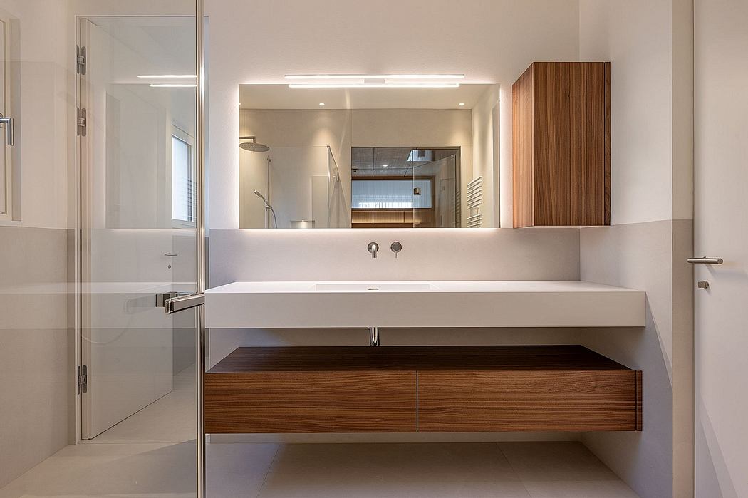 Spacious modern bathroom with wooden vanity, large mirror, and glass shower enclosure.