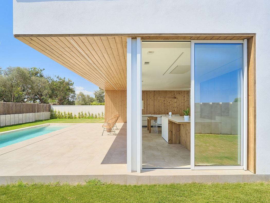A contemporary home with a wooden-paneled exterior, open-plan interior, and outdoor pool.