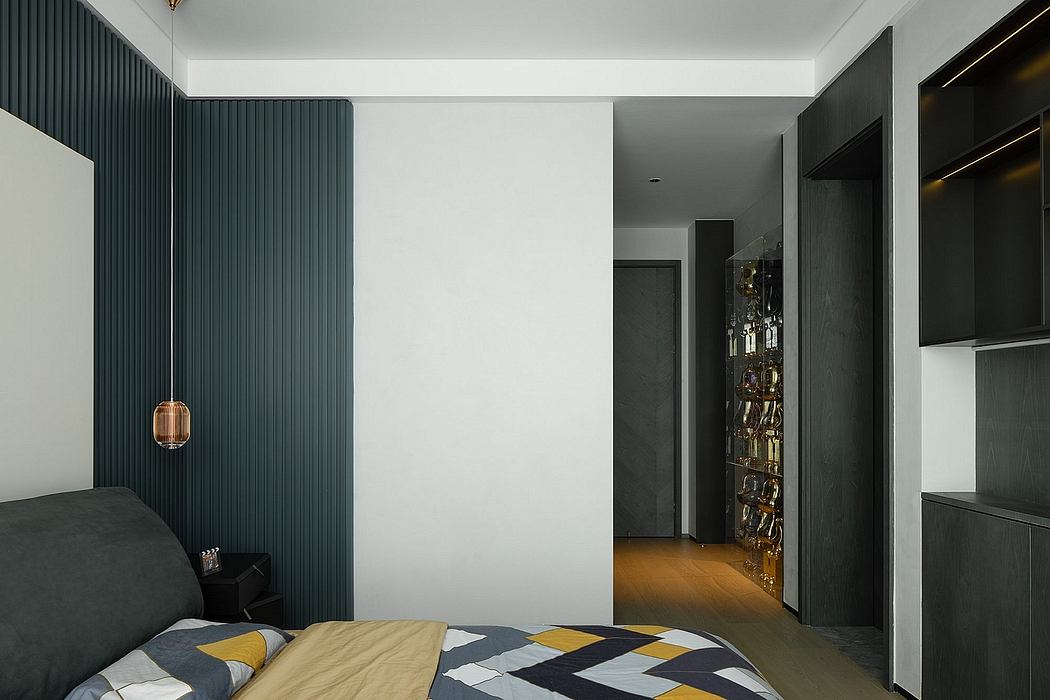 Modern, minimalist bedroom with dark paneled walls, recessed lighting, and a floating wall unit.