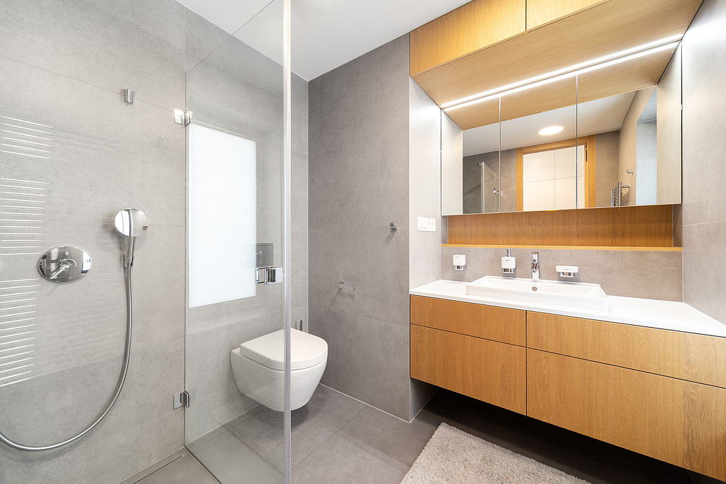 Sleek, modern bathroom design featuring clean lines, wood cabinetry, and minimalist fixtures.