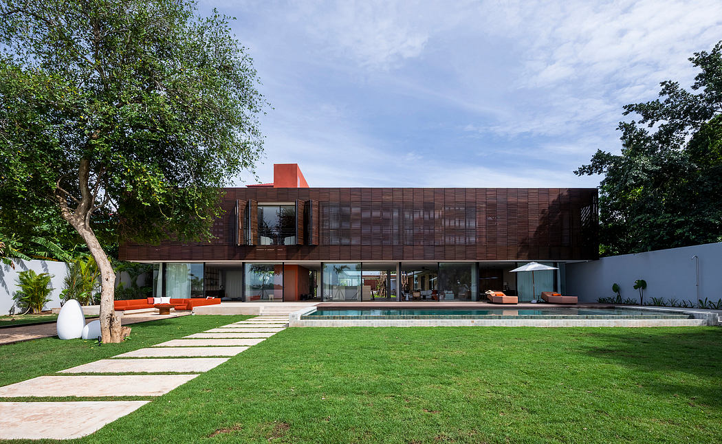 Striking modern architecture with wooden panels, glass windows, and an inviting pool area.
