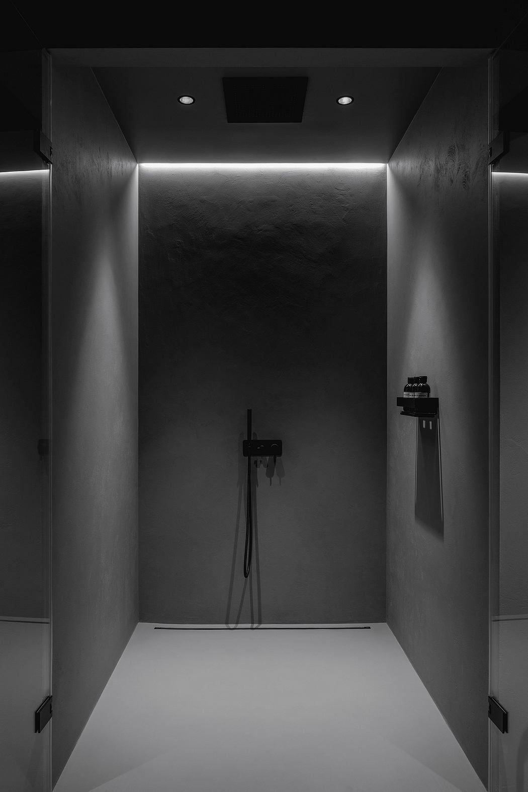 A minimalist bathroom design with a sleek, modern shower area and recessed lighting.