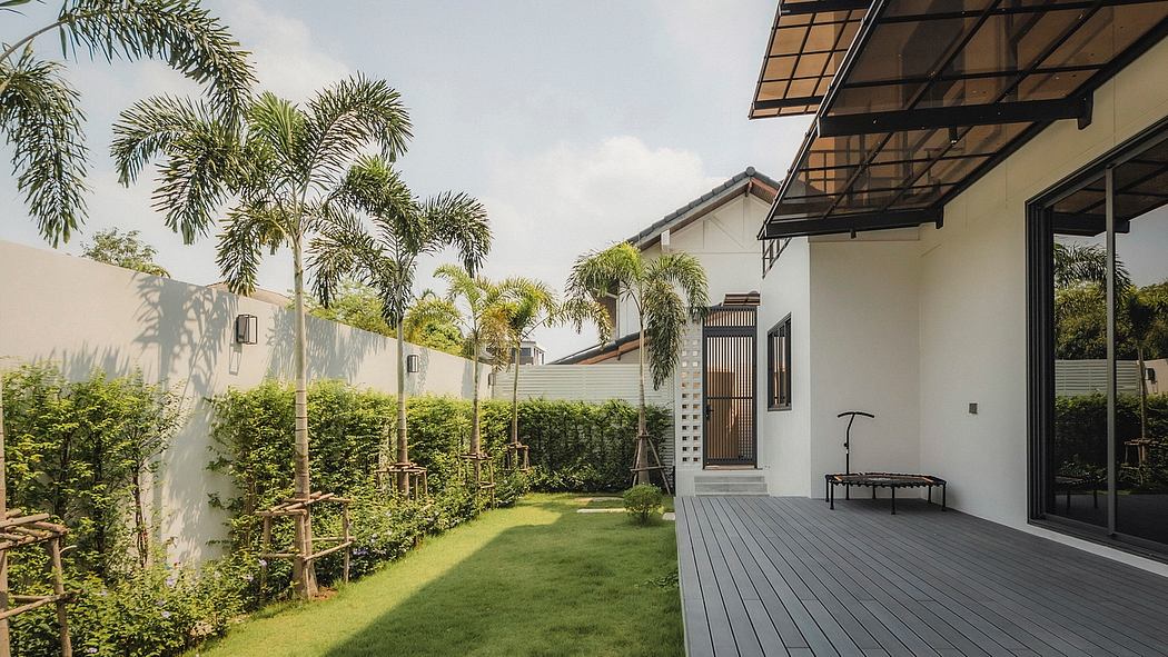 A modern, tropical-inspired home with a spacious outdoor deck, lush foliage, and sleek architectural elements.
