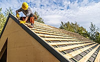 Professional Construction Worker Assembling Roof Wooden Elements