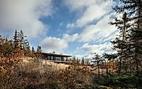 001-burnt-rock-olson-kundig-cabin-cantilevers-over-remote-minnesota-meadow.jpg