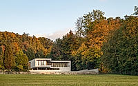 001-winkelhaus-curved-family-home-rooted-in-swiss-hillside-landscape.jpg