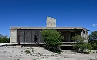 001-casa-cosmos-rammed-stone-and-exposed-concrete-on-a-sloped-site-edge.jpg
