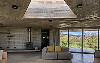 017-casa-cosmos-rammed-stone-and-exposed-concrete-on-a-sloped-site-edge.jpg