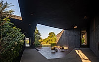 004-casa-mavra-turns-two-angular-volumes-into-a-black-concrete-house.jpg
