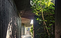 006-casa-mavra-turns-two-angular-volumes-into-a-black-concrete-house.jpg