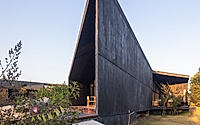 008-casa-mavra-turns-two-angular-volumes-into-a-black-concrete-house.jpg